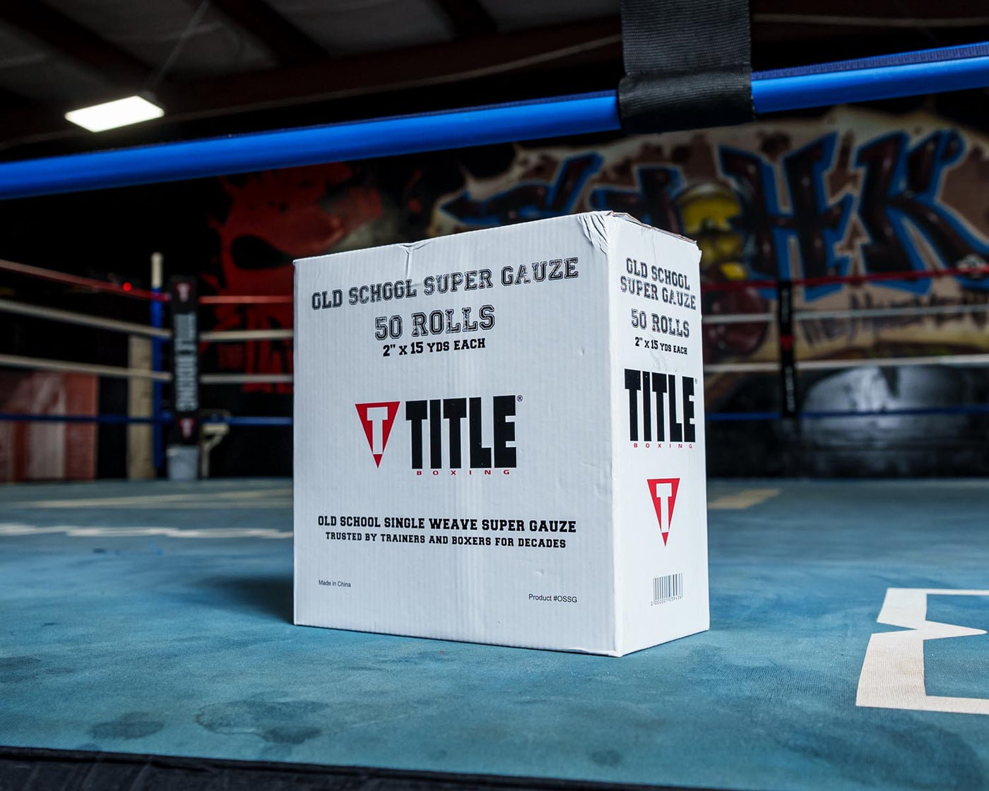 variant:lifestyle::TITLE Boxing Old School Super Gauze (50 Rolls) box on the floor of a boxing gym