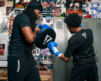 variant:lifestyle::TITLE Boxing Round Punch Shield coach with boxer uppecut
