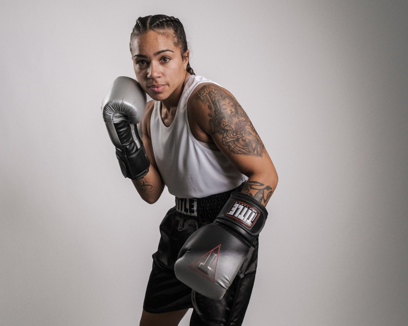 variant:lifestyle::TITLE Platinum Proclaim Power Boxing Bag Gloves girl posing wearing boxing gloves