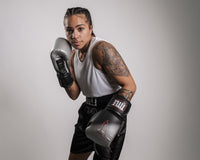 variant:lifestyle::TITLE Platinum Proclaim Power Boxing Bag Gloves girl posing wearing boxing gloves