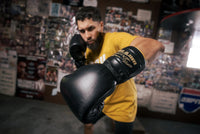 variant:lifestyle::TITLE Boxing Roberto Duran Leather Sparring Gloves guy posing with boxing gloves