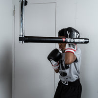 variant:lifestyle::TITLE Boxing Rapid-Reflex Bar boxer using a training bar