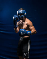 variant:lifestyle::TITLE Boxing Royalty Leather Training Headgear guy posing with headgear