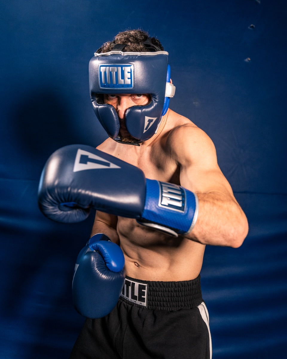 variant:lifestyle::TITLE Boxing Royalty Leather Training Headgear guy posing with gloves