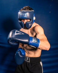 variant:lifestyle::TITLE Boxing Royalty Leather Training Headgear guy posing with gloves