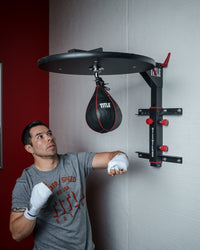 variant:lifestyle::TITLE Fold-Away Adjustable Speed Bag Platform 2.0 guy watching speed bag swing