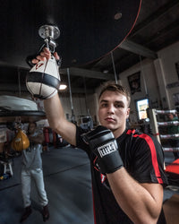 variant:lifestyle::TITLE Boxing Leather Super Speed Bag Gloves guy posing with gloves