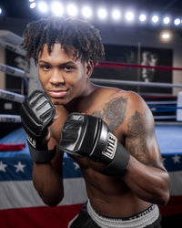 variant:lifestyle::TITLE Boxing Leather Super Speed Bag Gloves guy posing with gloves