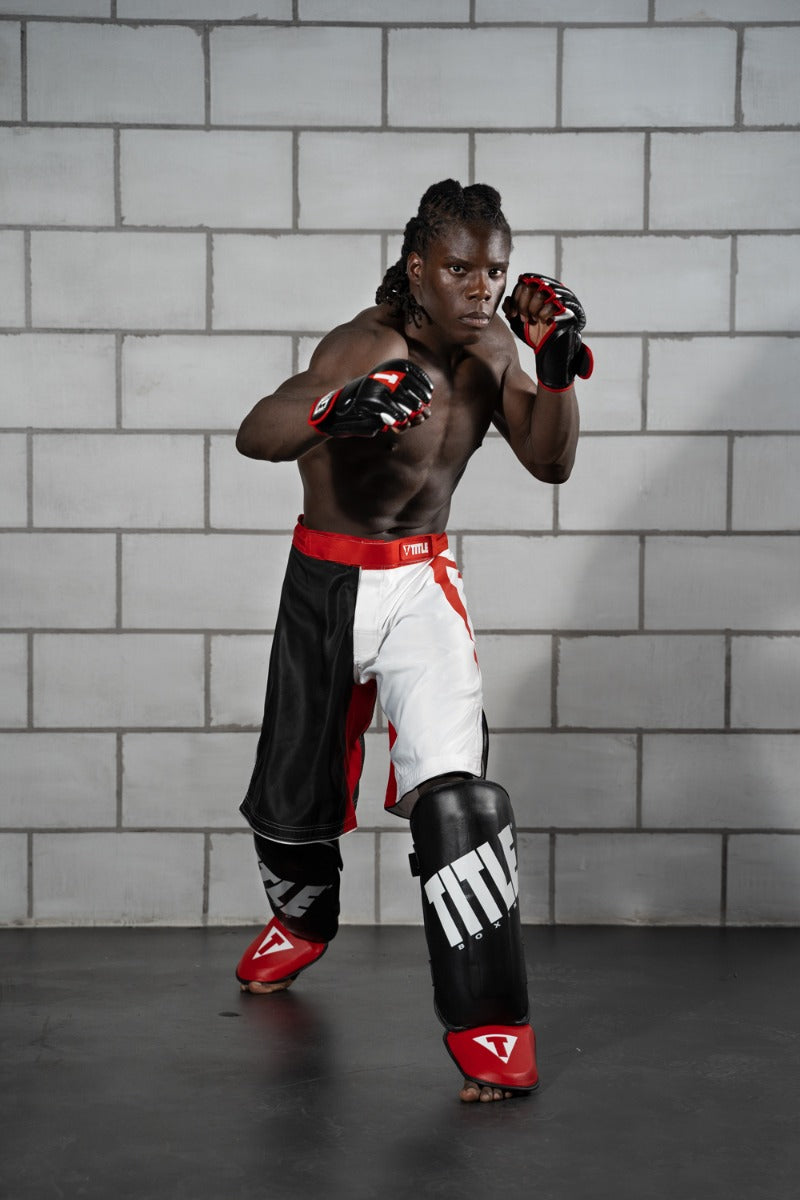 variant:lifestyle::TITLE Boxing Pro Style Shin & Instep Guards 3.0 guy posing in shin guards