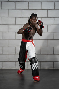 variant:lifestyle::TITLE Boxing Pro Style Shin & Instep Guards 3.0 guy posing in shin guards