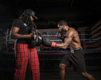 variant:lifestyle::TITLE Boxing Tombstone Training Shield guy hitting training shield 