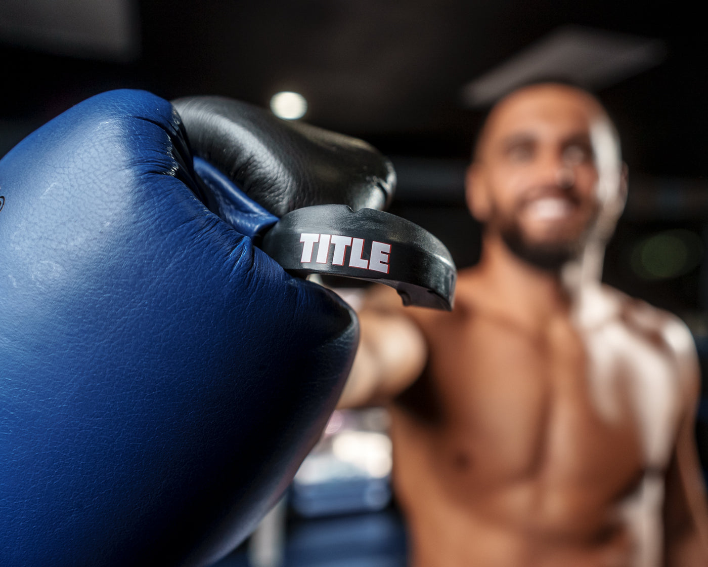 variant:black::TITLE Boxing Max Braces Mouthguard 2.0 close up guy holding