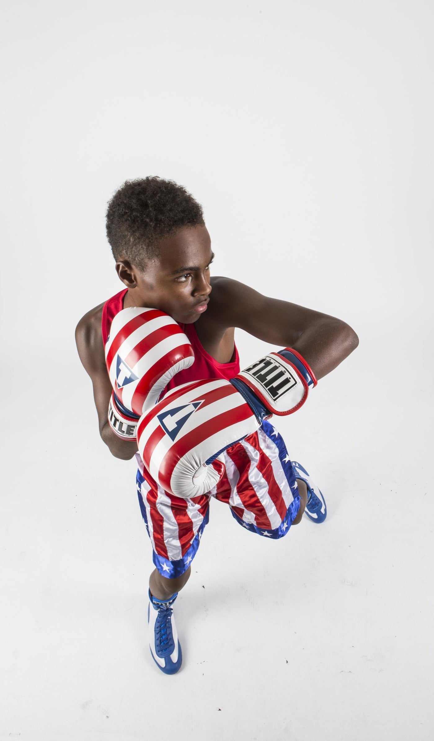 variant:lifestyle::TITLE Boxing Infused Foam Combat USA Training Gloves kid posing with boxing gloves