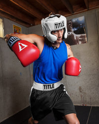 variant:lifestyle::TITLE Boxing Superior Lightweight Reversible Competition Jersey man striking with gloves