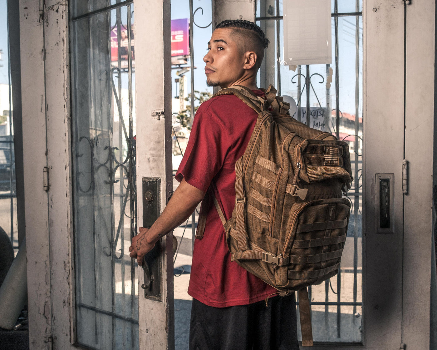 variant:Desert Sand::TITLE Boxing Tactical Combat Backpack man posing with backpack