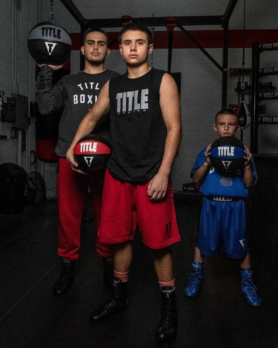 variant:6 lbs::TITLE Boxing Rubber Medicine Ball 3 people in a picture