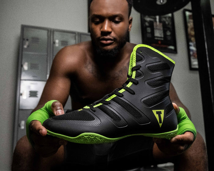 variant:Black/Neon Green::TITLE Boxing Total Balance Shoes  man holding shoes