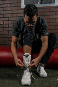 variant:White::TITLE Boxing Speed-Flex Encore High-Top Shoes man tying shoes