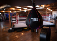 variant:lifestyle::TITLE Boxing Gyro Balanced Leather Speed Bag hanging in gym