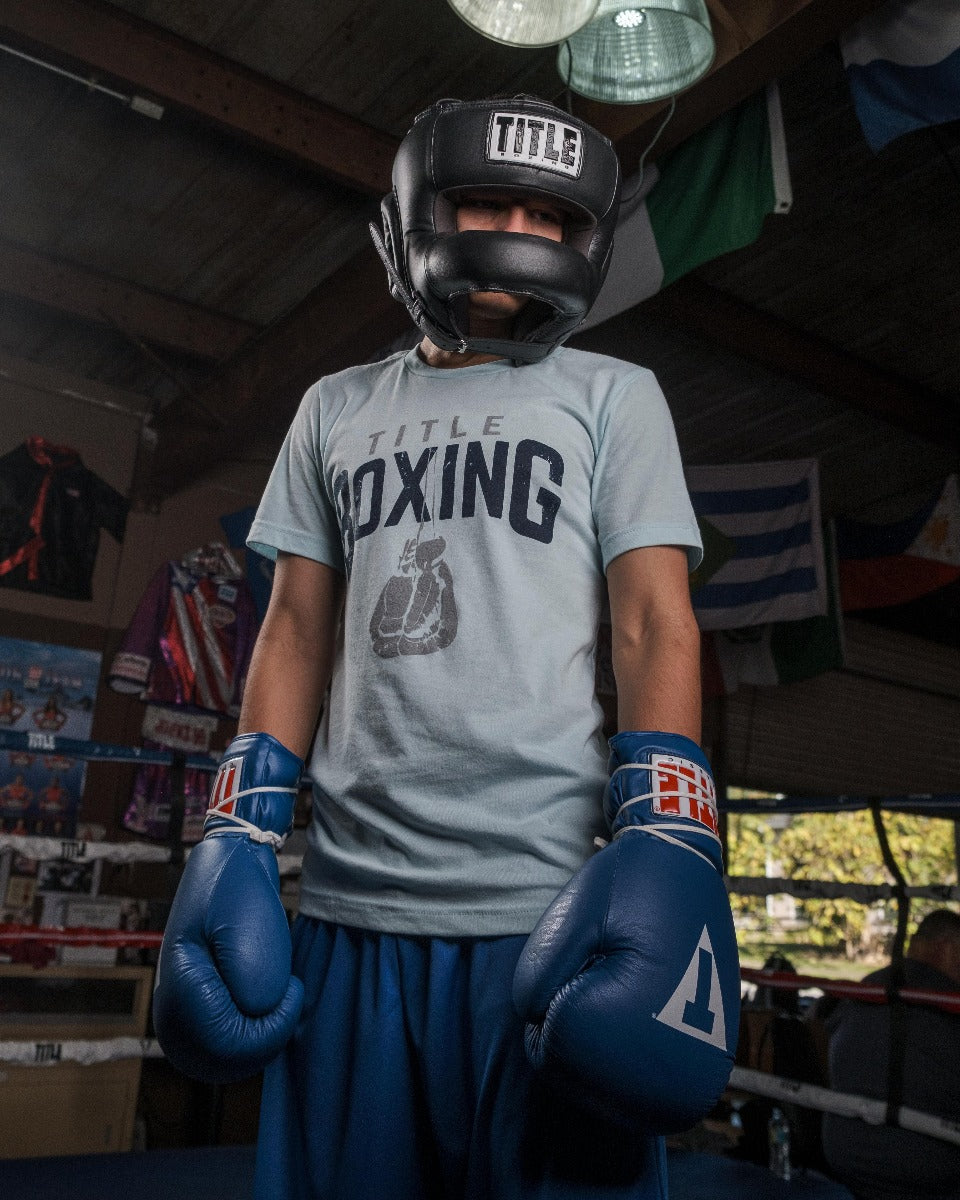 variant:Black::TITLE Boxing Face Protector Training Headgear man posing in headgear