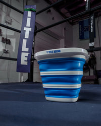 variant:lifestyle::TITLE Boxing Collapsible Bucket in a boxing ring