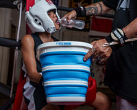 variant:lifestyle::TITLE Boxing Collapsible Bucket in use in a boxing ring