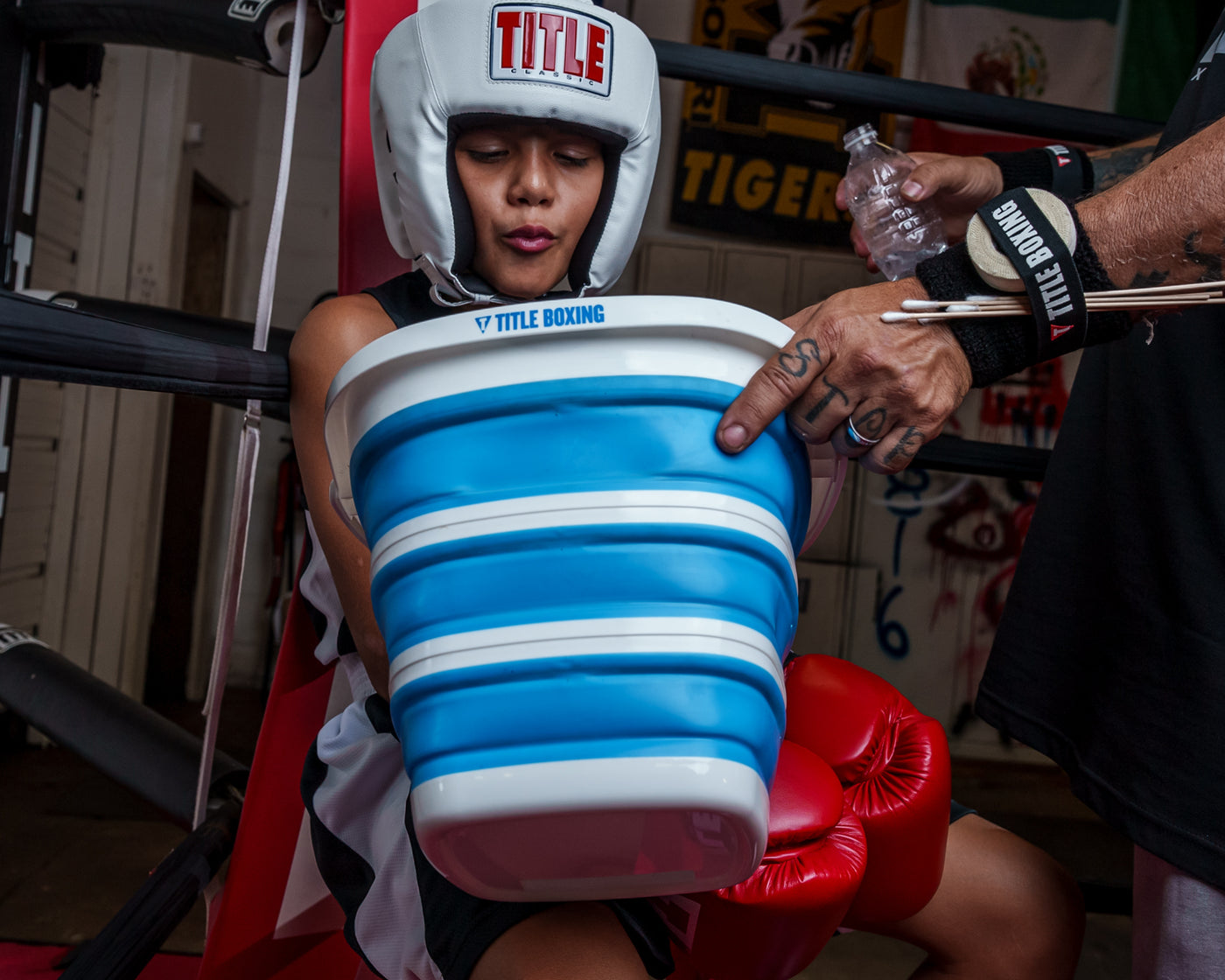 variant:lifestyle::TITLE Boxing Collapsible Bucket in use in a boxing match