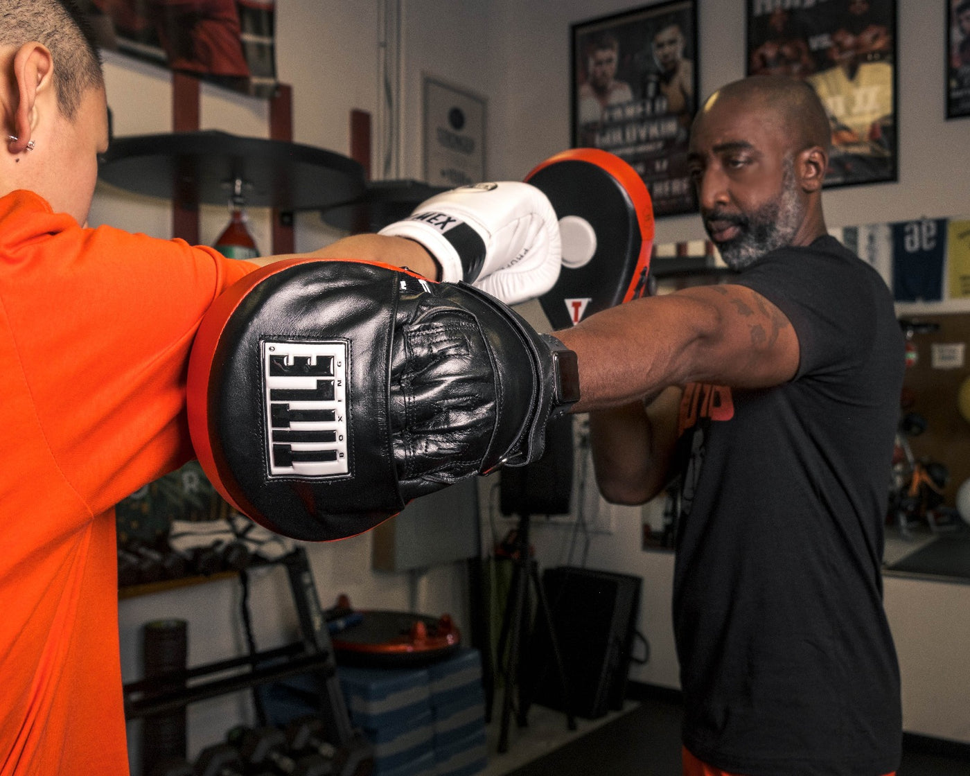 variant:lifestyle::TITLE Boxing Incredi-Ball Leather Punch Mitts 2.0 jab 