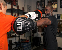 variant:lifestyle::TITLE Boxing Incredi-Ball Leather Punch Mitts 2.0 jab 