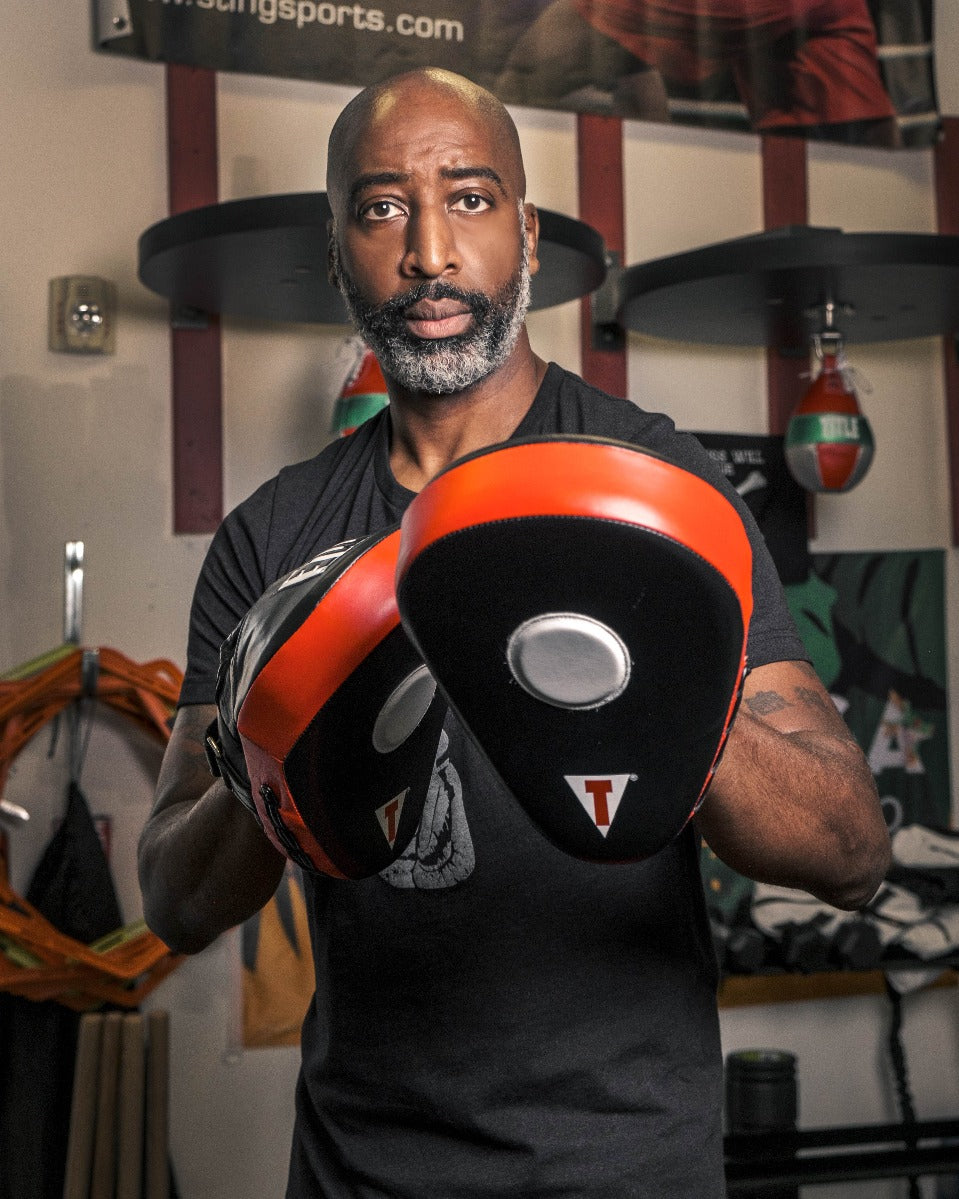 variant:lifestyle::TITLE Boxing Incredi-Ball Leather Punch Mitts 2.0 coach mitting