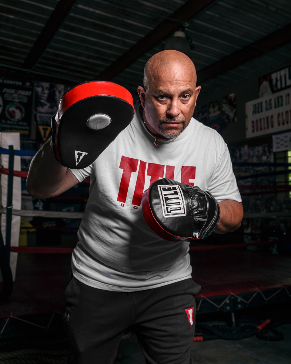 variant:lifestyle::TITLE Boxing Incredi-Ball Leather Punch Mitts 2.0 alt. coach stance