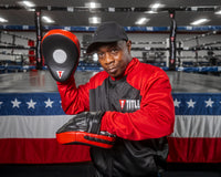 variant:lifestyle::TITLE Boxing Incredi-Ball Leather Punch Mitts 2.0 coach stance mitts