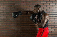 variant:lifestyle::TITLE Black Blitz Sparring Gloves guy giving right jab
