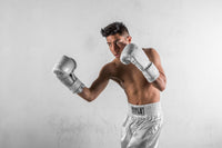 variant:lifestyle::TITLE White Boxing Heavy Bag Gloves main modeling gloves