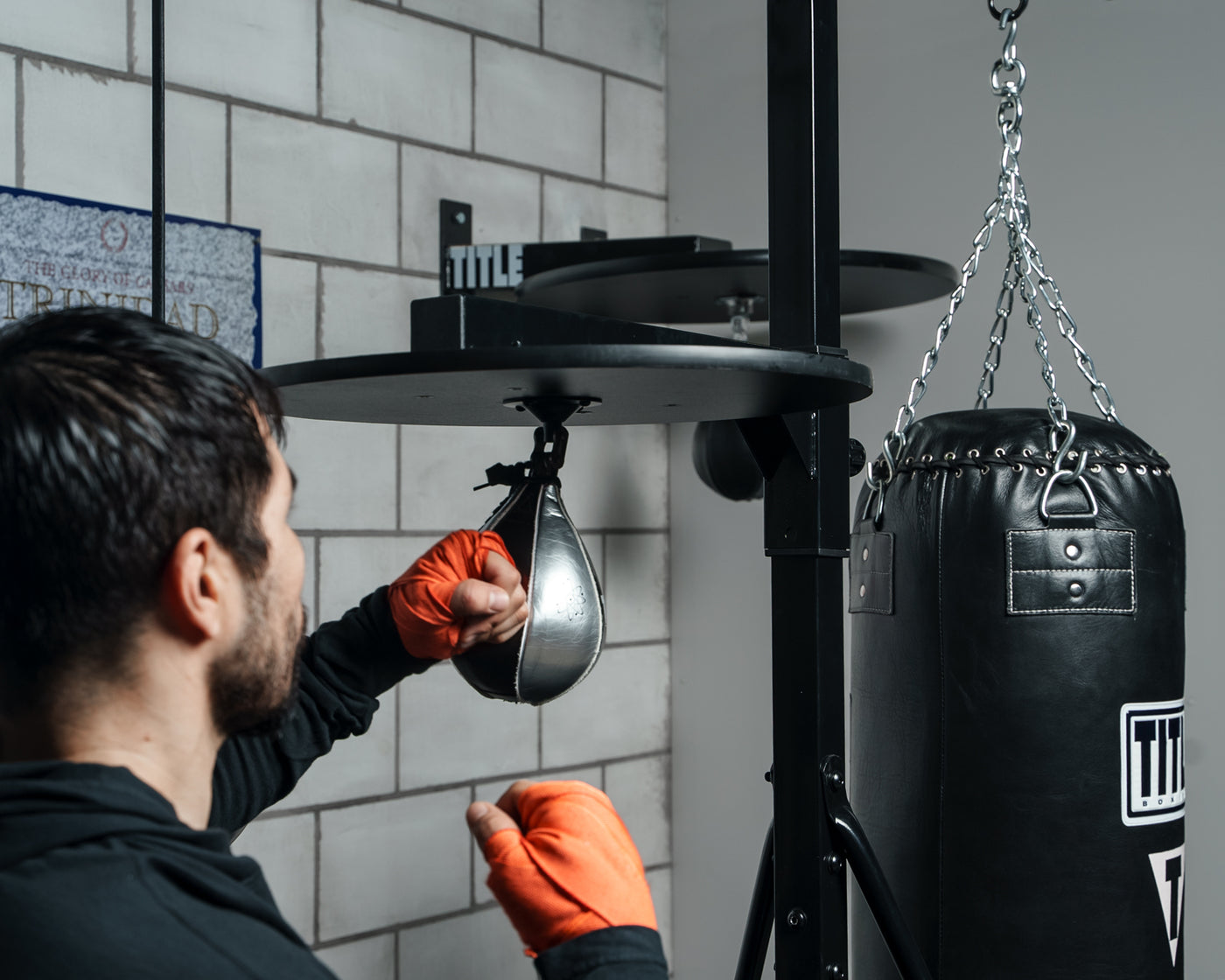 variant:lifestyle::TITLE Boxing Heavy Bag And Speed Bag Stand in use in a boxing gym