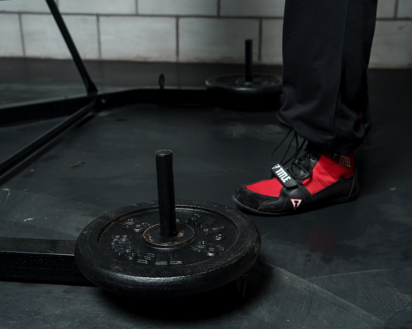 variant:lifestyle::TITLE Boxing Heavy Bag And Speed Bag Stand view on the floor of a boxing gym with weights