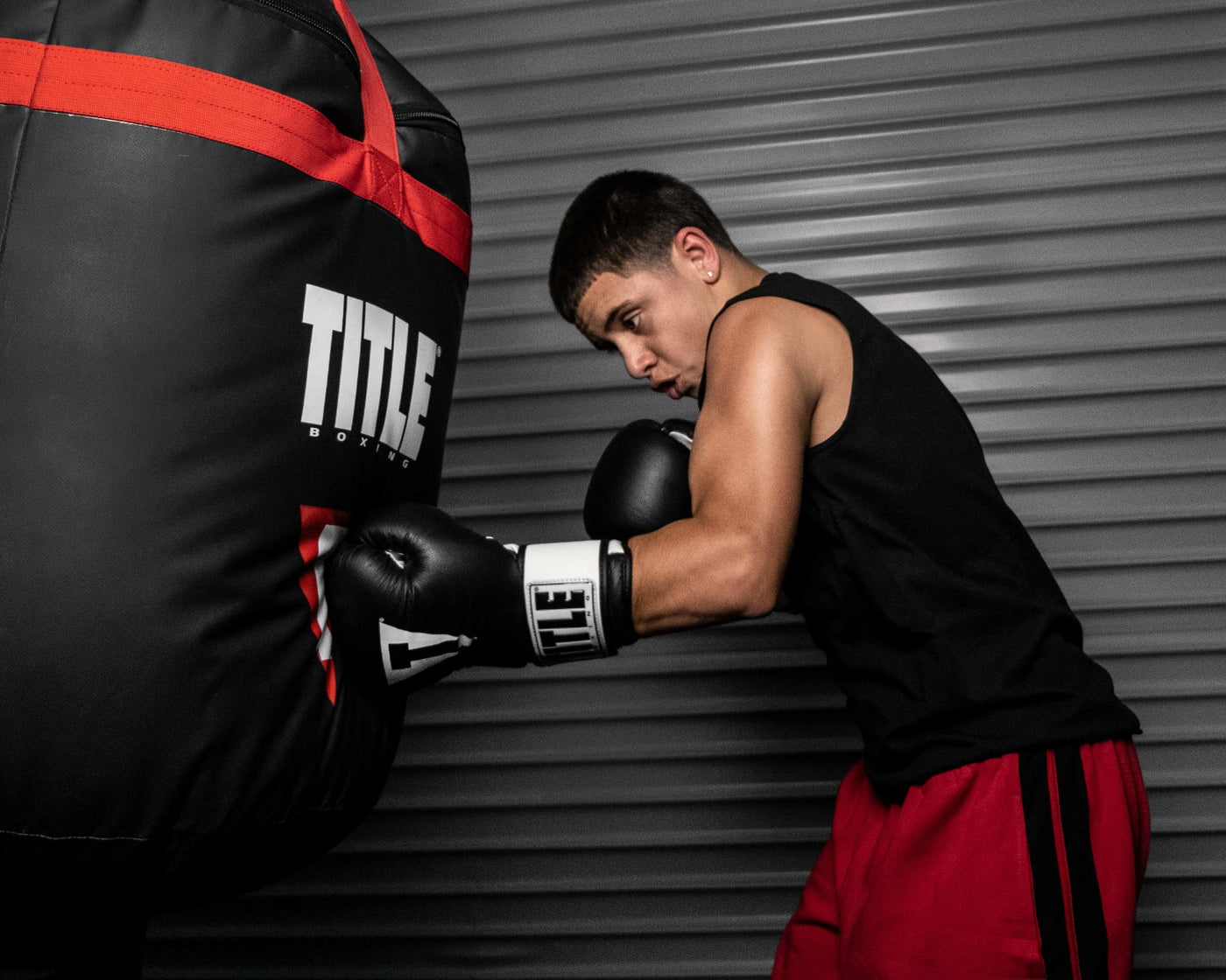 variant:Black/White::TITLE Premier Leather Super Bag Gloves 2.0 boy hitting heavy bag