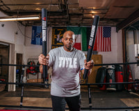 variant:lifestyle::TITLE Boxing Precision Training Sticks 2.0 coach in ring