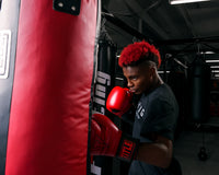 variant:lifestyle::TITLE Boxing Synthetic Leather Heavy Bag (Unfilled) man posing with bag
