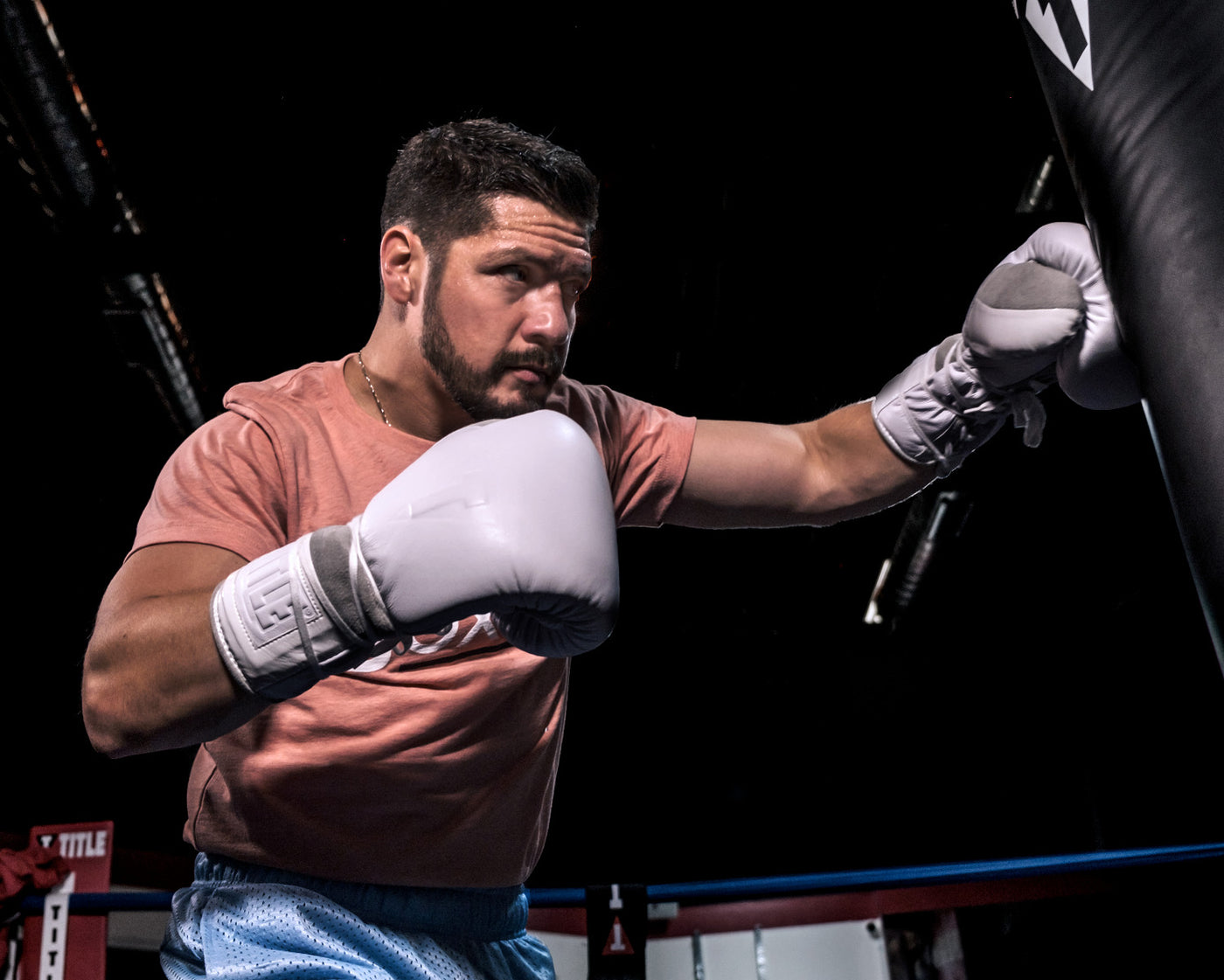variant:lifestyle::TITLE White Boxing Lace Sparring Gloves 2.0 main hitting bag wearing gloves