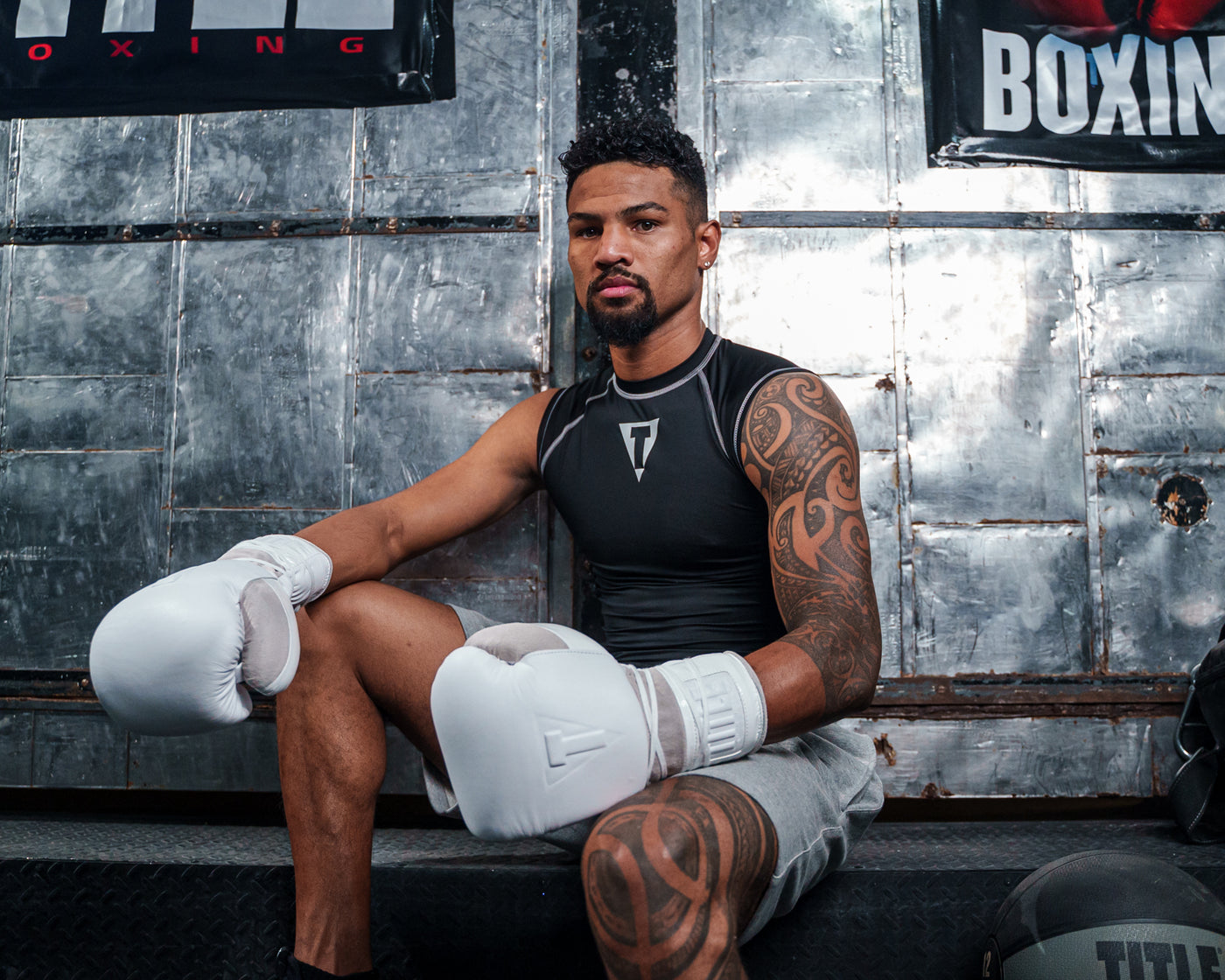 variant:lifestyle::TITLE White Boxing Lace Sparring Gloves 2.0 man posing wearing white sparring gloves