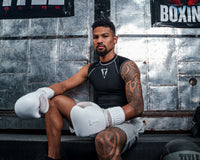 variant:lifestyle::TITLE White Boxing Lace Sparring Gloves 2.0 man posing wearing white sparring gloves