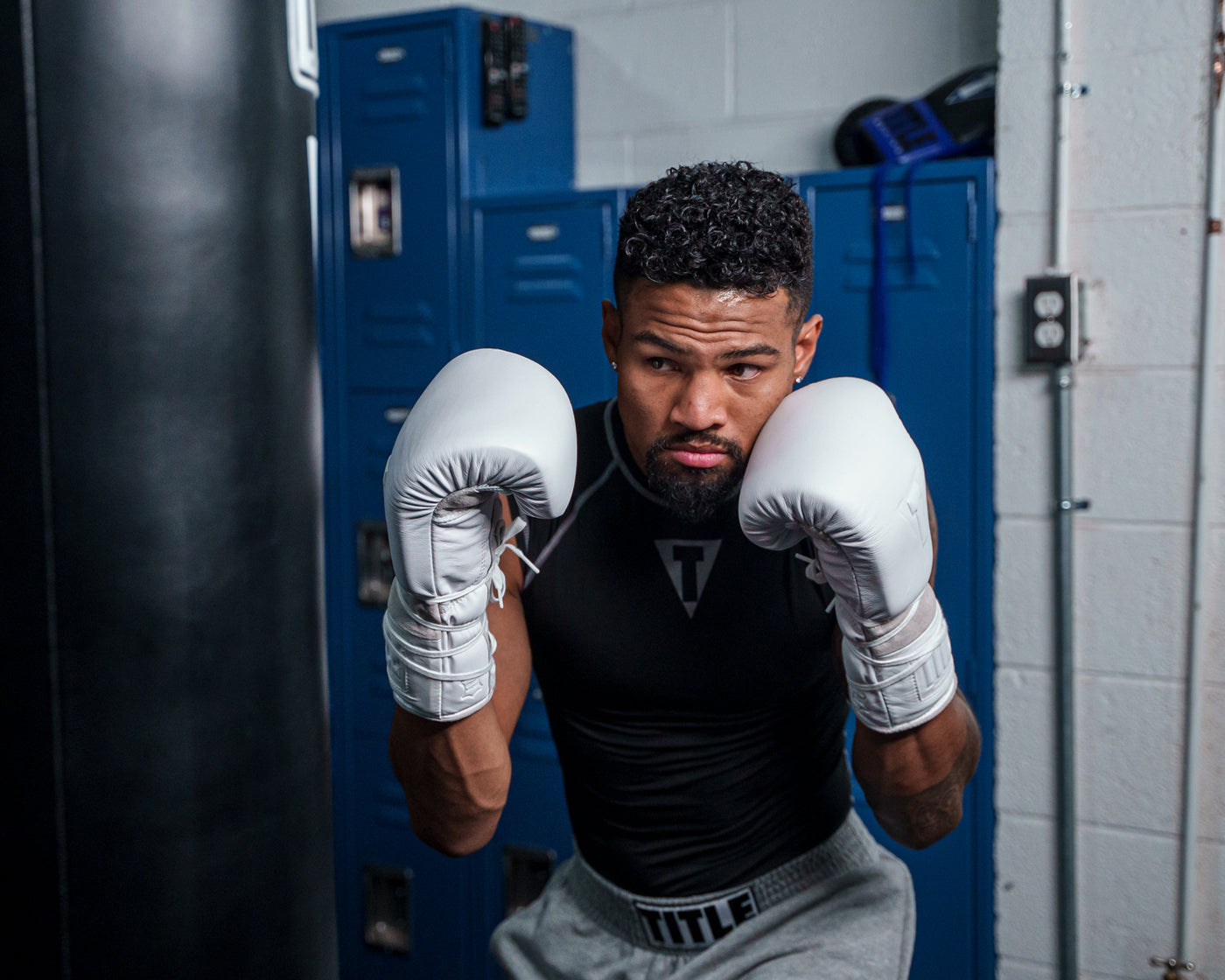 variant:lifestyle::TITLE White Boxing Lace Sparring Gloves 2.0 man wearing gloves posing