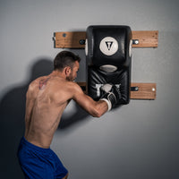 variant:lifestyle::TITLE Boxing Wall Mount Menace Training Bag front view on boxing gym wall