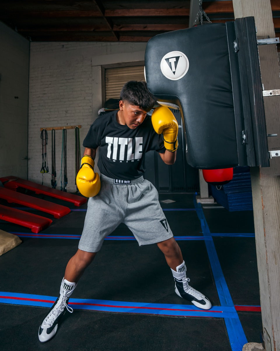 variant:lifestyle::TITLE Boxing Wall Mount Menace Training Bag in use in a boxing gym