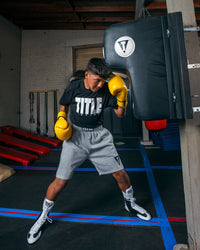 variant:lifestyle::TITLE Boxing Wall Mount Menace Training Bag in use in a boxing gym