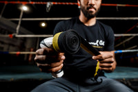 variant:lifestyle::TITLE Boxing Wrap Wrench with a boxer using it to roll a hand wrap