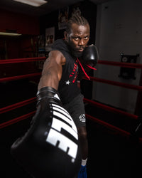 variant:Black/Silver::TITLE Boxing Leather Enforcer Pro Sparring Gloves man posing with gloves