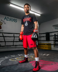 variant:lifestyle::TITLE Boxing Pro Style Heavy Bag Gloves man posing in gloves standing in ring