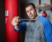 variant:lifestyle::TITLE Boxing Portable Zip Hand Wrap Roller in a boxing gym